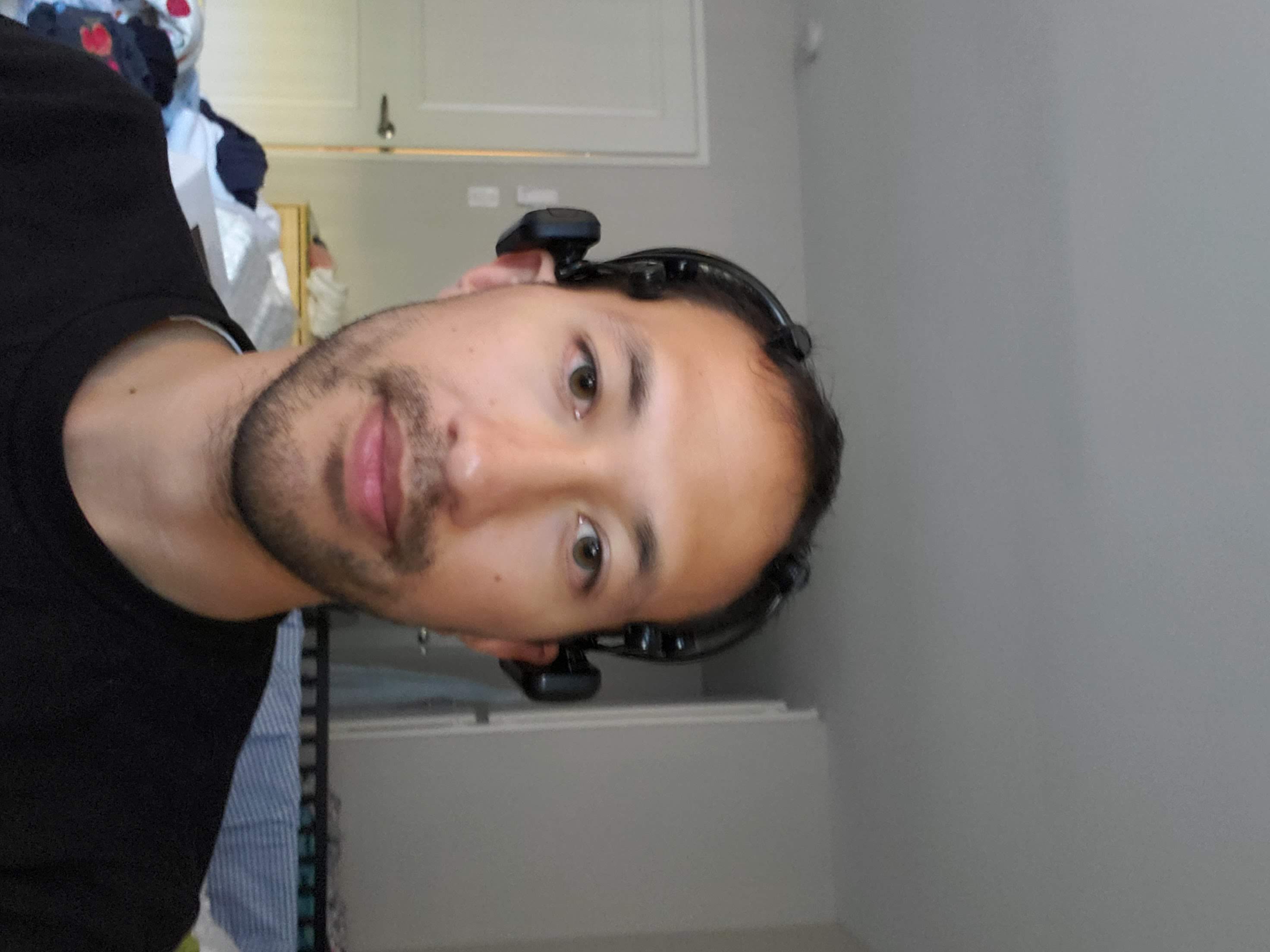 Portrait of Daniel Nash wearing the Emotiv EPOC+ during development.